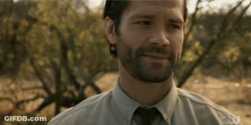 A Man With A Beard Is Smiling And Wearing A Shirt That Says Fox GIF