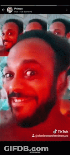 A Man With A Beard Is Smiling In A Tiktok Video . GIF