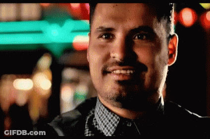 Smiling Man With Beard In Front Of Green Sign GIF