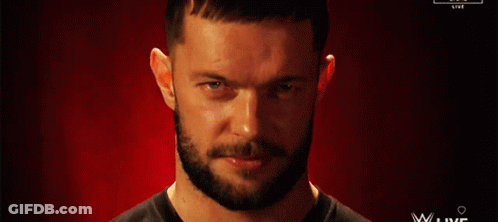 A Man With A Beard Is Smiling In Front Of A Red Background That Says Wwe Live GIF