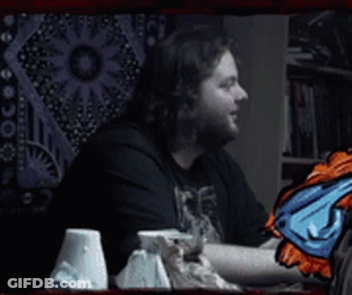 A Man With A Beard Is Smiling In Front Of A Wall Tapestry And The Words Dafug ? GIF