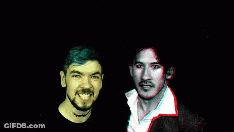 A Man With A Beard Is Smiling Next To Another Man With Red Eyes GIF