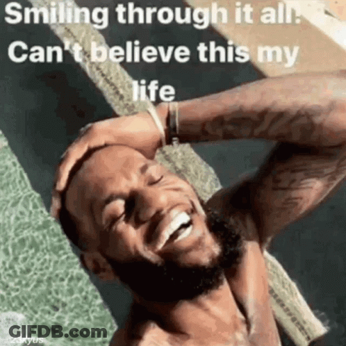 A Man With A Beard Is Smiling Through It All And Can 'T Believe This Is My Life . GIF