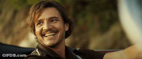 A Man With A Beard Is Smiling While Driving A Car GIF