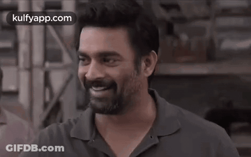A Man With A Beard Is Smiling With His Eyes Closed In A Black And White Photo . GIF