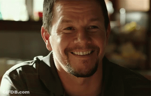 A Man With A Beard Is Smiling With His Teeth Visible GIF