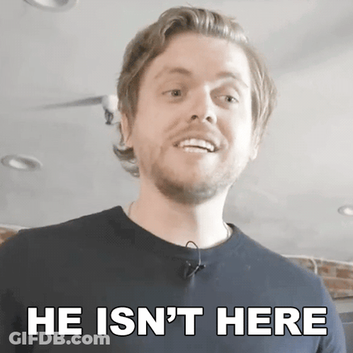 A Man With A Beard Is Smiling With The Words He Is N't Here Below Him GIF