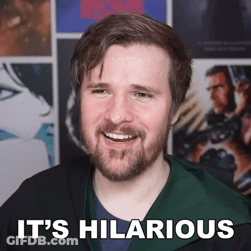 A Man With A Beard Is Smiling With The Words It 'S Hilarious Below Him GIF