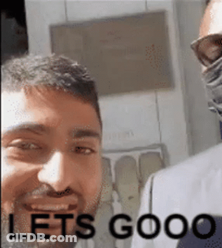 A Man With A Beard Is Smiling With The Words Let 'S Goooo Written Below Him . GIF