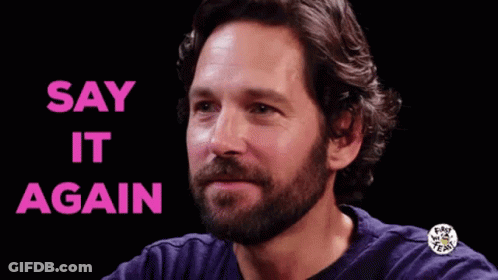 A Man With A Beard Is Smiling With The Words `` Say It Again '' Written Above Him . GIF