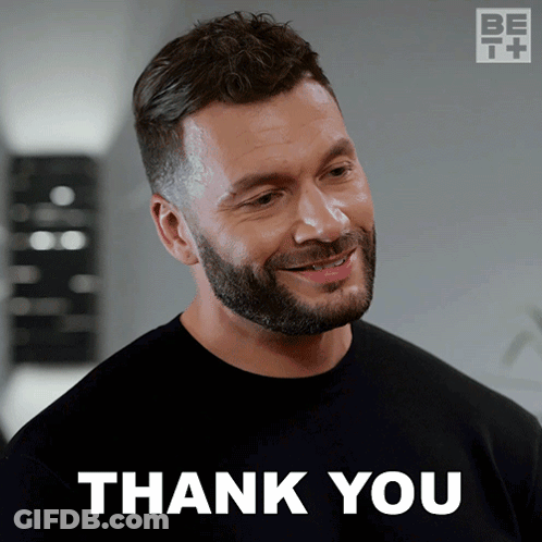 A Man With A Beard Is Smiling With The Words Thank You Behind Him GIF