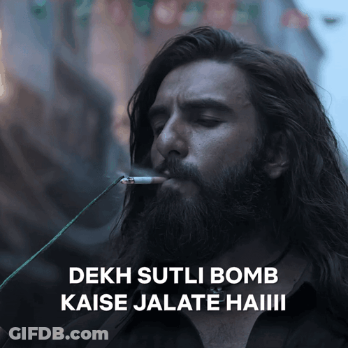 A Man With A Beard Is Smoking A Cigarette And Says " Dekh Sutli Bomb " GIF
