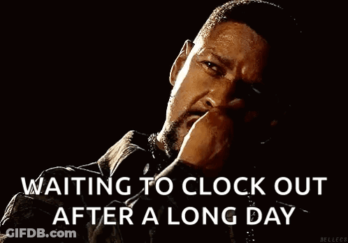A Man With A Beard Is Smoking A Cigarette In The Dark . GIF