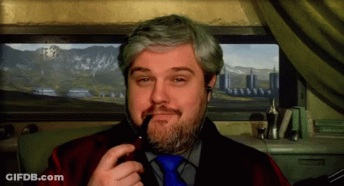 A Man With A Beard Is Smoking A Pipe In Front Of A Picture Of Mountains GIF