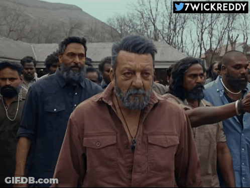 A Man With A Beard Is Standing In A Crowd With A 7Wickreddy Logo On The Bottom GIF