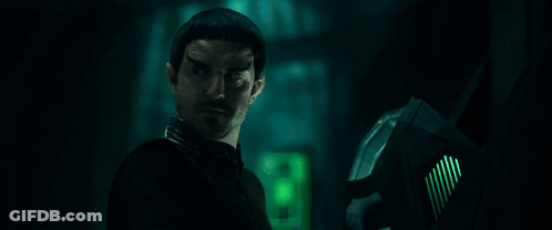 Bearded Man Standing In Dark Room With All According To Plan GIF