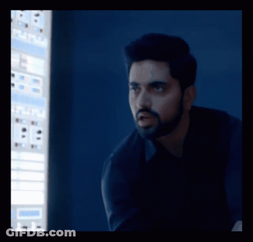 A Man With A Beard Is Standing In Front Of A Computer Screen That Says ' A ' On It GIF