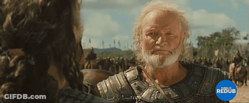 A Man With A Beard Is Standing In Front Of A Crowd And A Blue Circle That Says Parello Redub GIF
