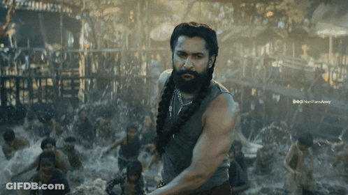 A Man With A Beard Is Standing In Front Of A Crowd Of People And A Watermark That Says Nanparaarmy GIF