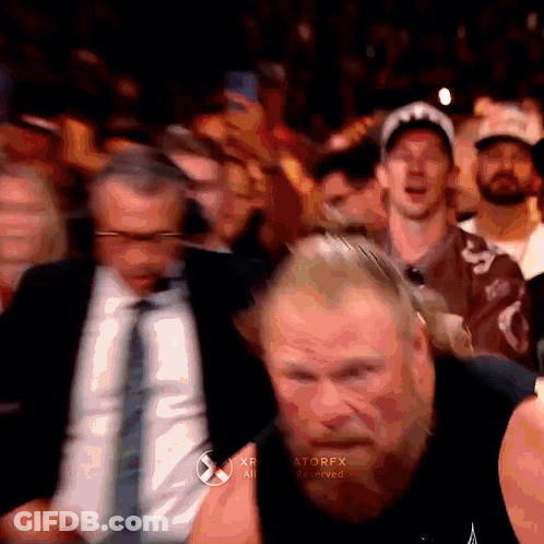 A Man With A Beard Is Standing In Front Of A Crowd With The Word Atorfx On The Bottom Right Corner GIF