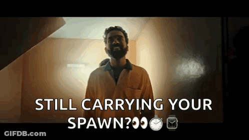 A Man With A Beard Is Standing In Front Of A Door And Says Still Carrying Your Spawn GIF