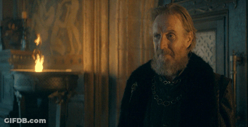 A Man With A Beard Is Standing In Front Of A Fire With The Word You Above Him GIF