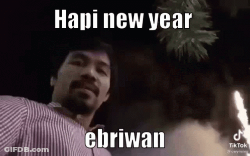 A Man With A Beard Is Standing In Front Of A Fireworks Display And Says Hapi New Year Ebriwan . GIF