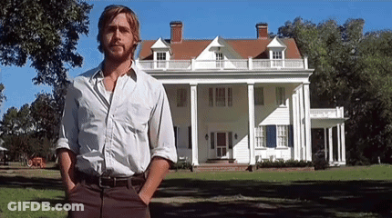 A Man With A Beard Is Standing In Front Of A Large White House . GIF