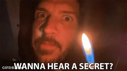 A Man With A Beard Is Standing In Front Of A Lit Candle And Says Wanna Hear A Secret ? GIF