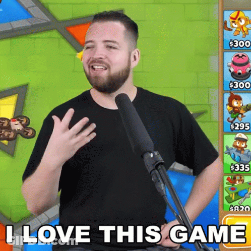 A Man With A Beard Is Standing In Front Of A Microphone And Says I Love This Game GIF