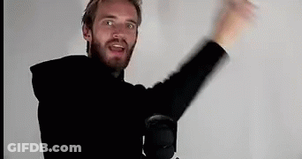 A Man With A Beard Is Standing In Front Of A Microphone With His Arms In The Air . GIF