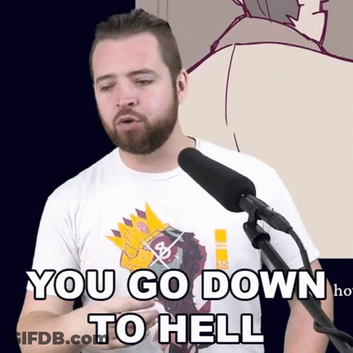 A Man With A Beard Is Standing In Front Of A Microphone With The Words You Go Down To Hell Written On His Shirt GIF