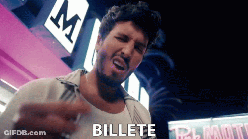 A Man With A Beard Is Standing In Front Of A Sign That Says " Billete " GIF