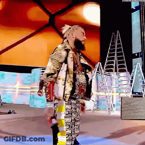 A Man With A Beard Is Standing In Front Of A Sign That Says ' Ethenextthing ' On It GIF