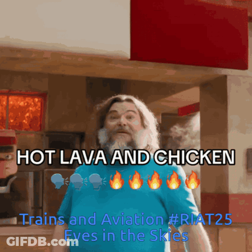 A Man With A Beard Is Standing In Front Of A Sign That Says Hot Lava And Chicken GIF