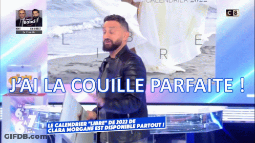 A Man With A Beard Is Standing In Front Of A Sign That Says J'ai La Coulle Parfaite GIF
