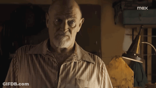 A Man With A Beard Is Standing In Front Of A Sign That Says Mox GIF