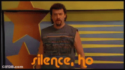 A Man With A Beard Is Standing In Front Of A Sign That Says Silence Ho GIF