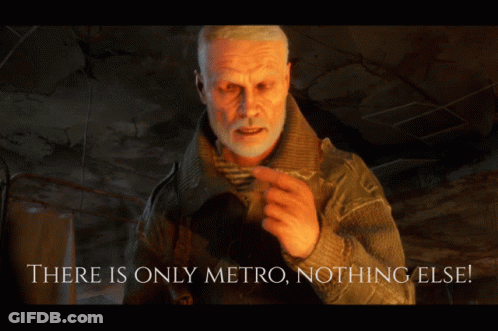 A Man With A Beard Is Standing In Front Of A Sign That Says " There Is Only Metro Nothing Else " GIF