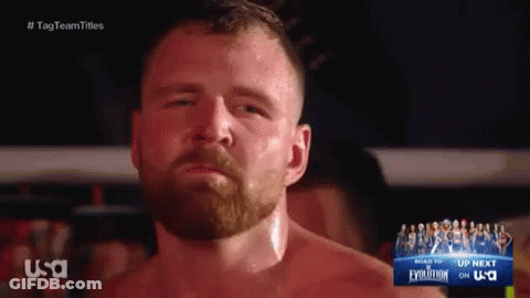 A Man With A Beard Is Standing In Front Of A Sign That Says USA GIF