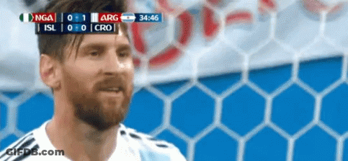 A Man With A Beard Is Standing In Front Of A Soccer Goal During A Game . GIF