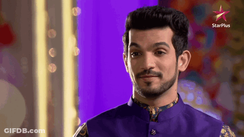 A Man With A Beard Is Standing In Front Of A Star Plus Sign GIF