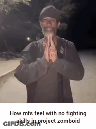 A Man With A Beard Is Standing In Front Of A Street With His Hands Folded In Prayer . GIF