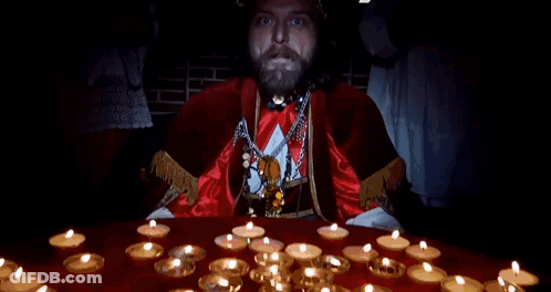A Man With A Beard Is Standing In Front Of A Table With Candles And Says I Am The Pope Of Dope GIF