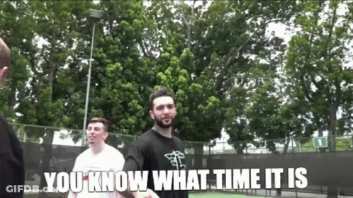 A Man With A Beard Is Standing In Front Of A Tennis Court With The Words " You Know What Time It Is " Below Him GIF