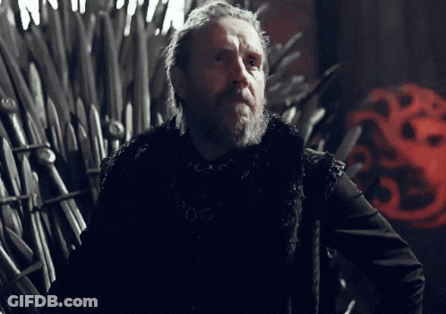 A Man With A Beard Is Standing In Front Of A Throne With A Red Dragon On It GIF