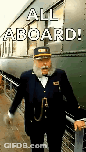 A Man With A Beard Is Standing In Front Of A Train . GIF
