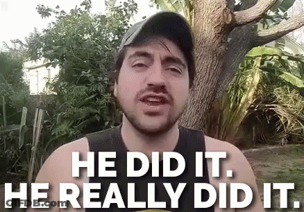 A Man With A Beard Is Standing In Front Of A Tree And Says He Did It He Really Did It . GIF
