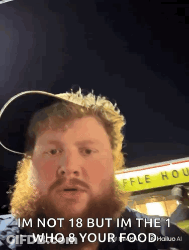 A Man With A Beard Is Standing In Front Of A Waffle House .. GIF