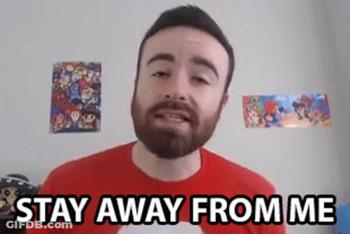 A Man With A Beard Is Standing In Front Of A Wall With Posters On It And Says `` Stay Away From Me '' . GIF